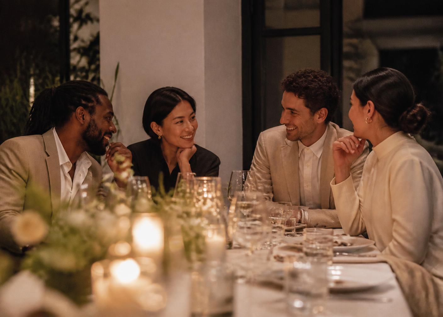 Members in relaxed conversation at a private dinner
